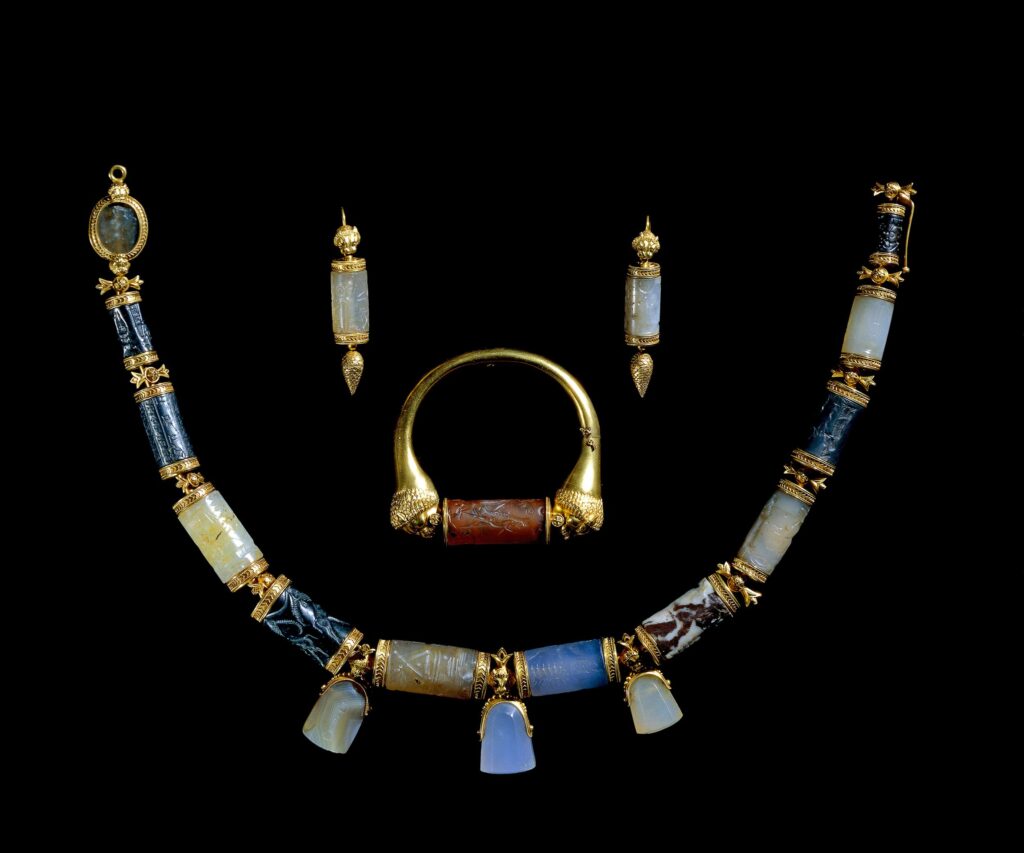 Necklace , earrings and ring made up from Assyrian seals from the collection of Sir Austin Henry Layard as a wedding present for his bride Enid Guest. 