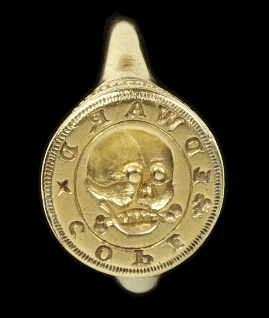 Gold signet ring, with a circular bezel engraved with a skull surrounded by the name 'EDWARD x COPE', with behind a fragment of bone, presumably a talisman or relic, England, early 1600-50.