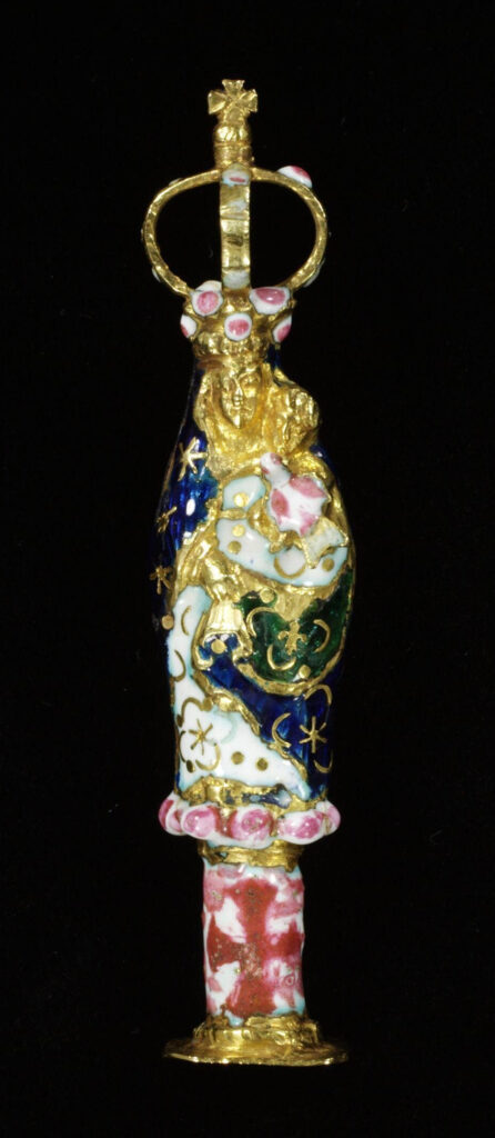 Moon symbolism:  Cast pendant in the form of a figure of the Virgin of the Pillar The base of the jewel is decorated with a red enamel cross. Her blue and white robe is enamelled with stars and sickle moons. The top of the jewel is formed of a large openwork crown and there is a gold loop on the Virgin's back. 