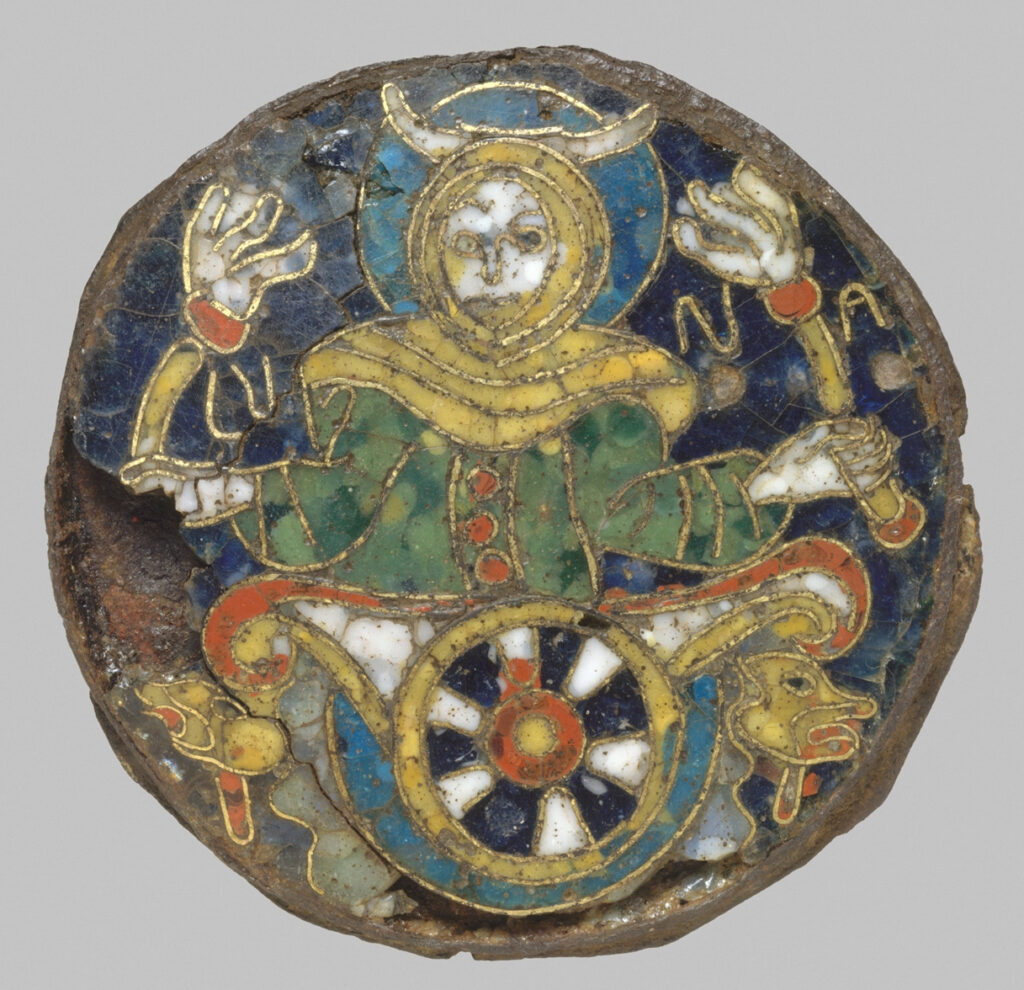 Cloisonne enamel roundel showing the moon as a woman wearing a green dress with red buttons and a yellow cape around her shoulders. She is seated in a chariot with a single central wheel enamelled in black, white and red. She holds a torch  in each hand is wears a crescent moon on her head, with a blue circular roundel behind her head. 