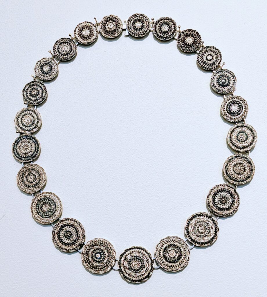 Necklace made up of circles of woven wire by Andrew Lamb. Craft Scotland, Collect 2024. 