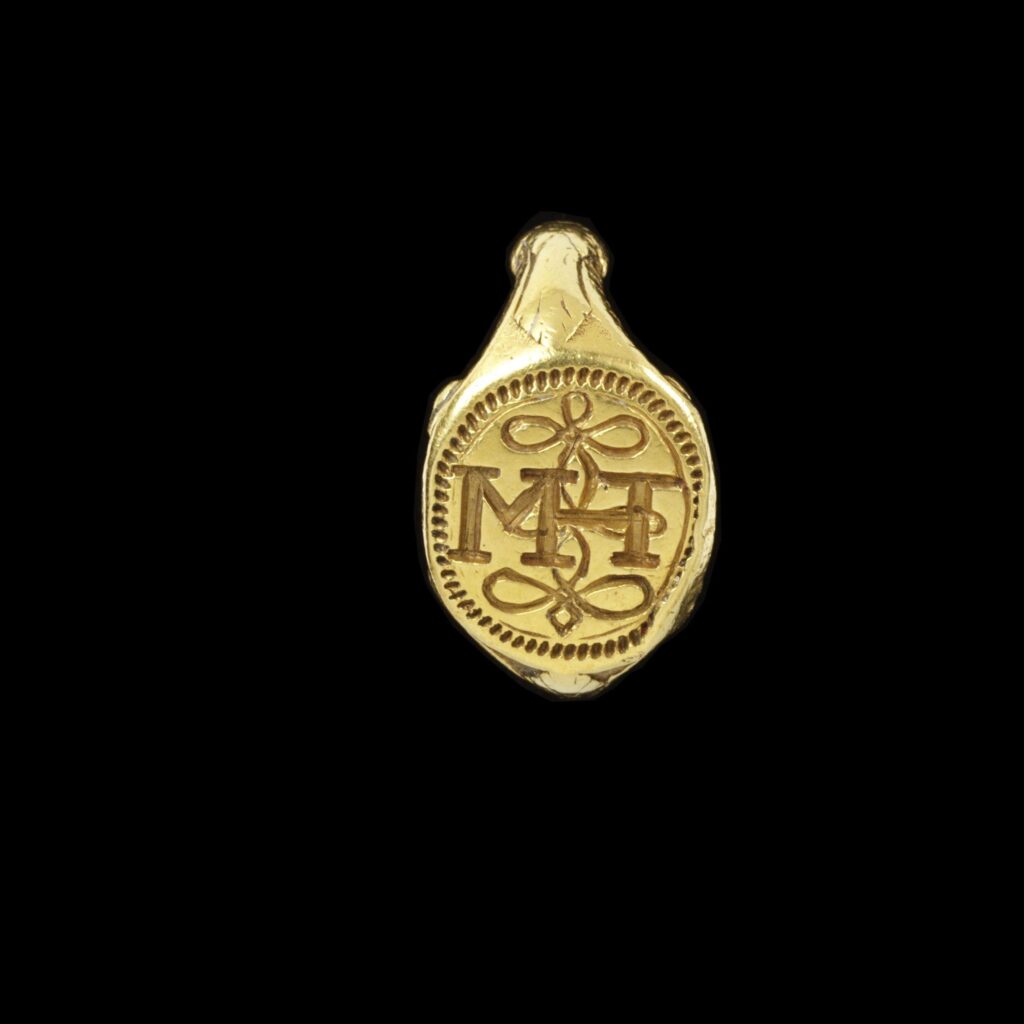 'Darnley' ring. Gold signet ring with the initials M and H joined with a true lover's knot. Part of Edmund Waterton's ring collection. 