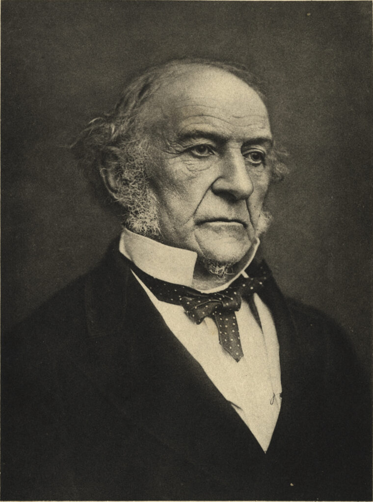 Black and white photograph of William Gladstone as an old man, wearing a dark jacket, with a pale shirt and spotted necktie. By Samuel Alexander Walker, 1892. 